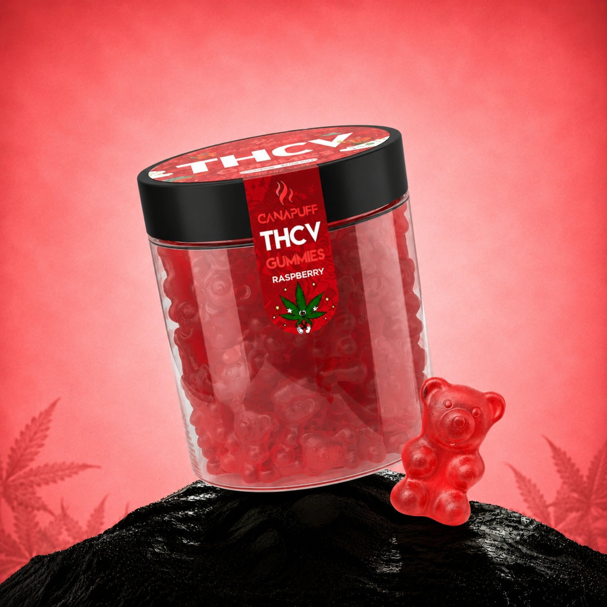 Canapuff THCv Gummies Raspberry in clear jar with black lid, red gummies and bear-shaped gummy beside on black rock